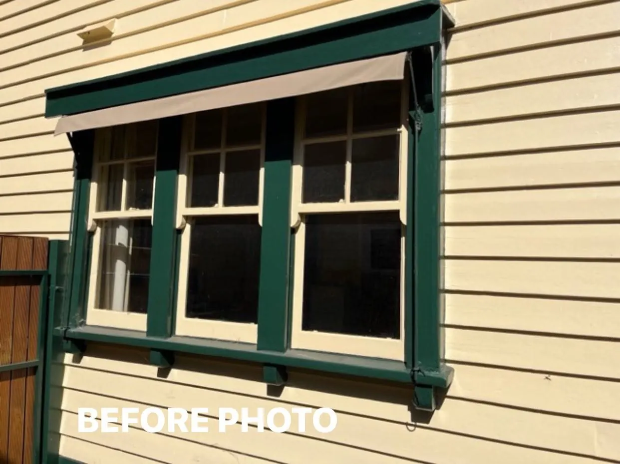 Double-hung windows before restoration, with worn paint