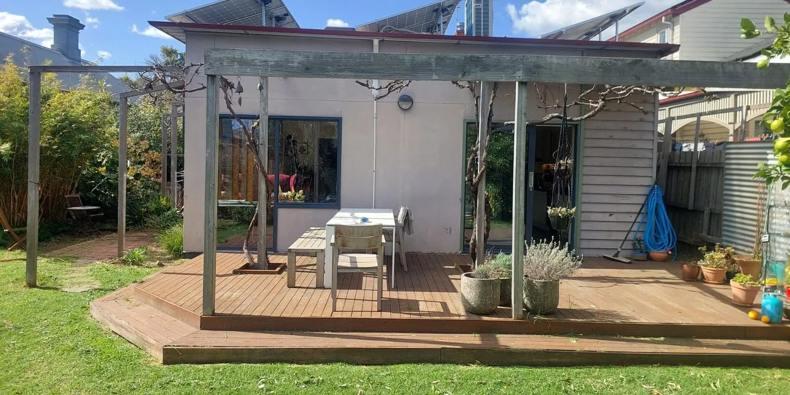 Rear of a Melbourne home with a new pergola, timber deck and garden