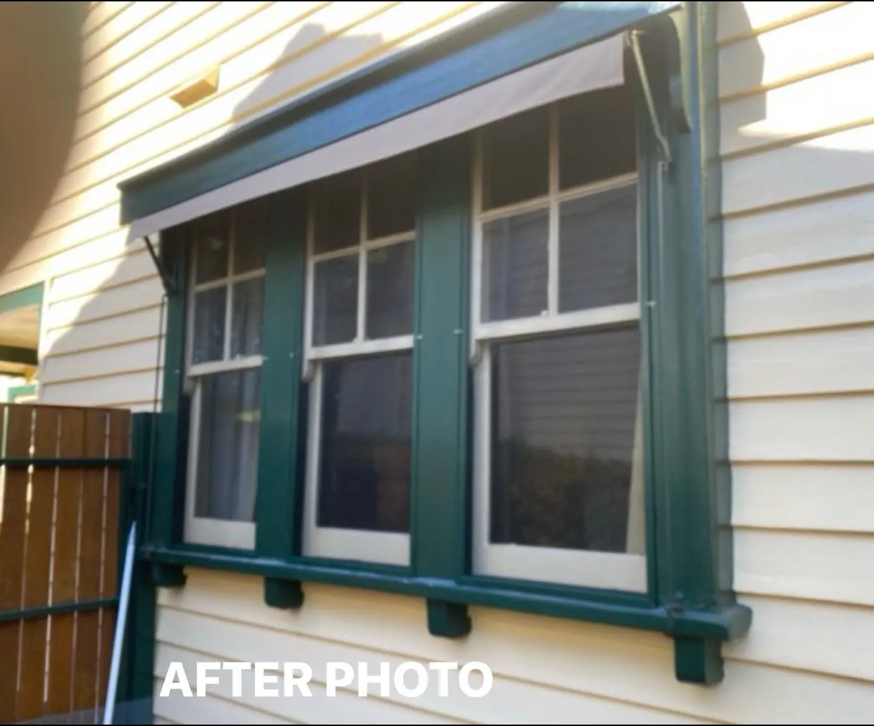 The same windows after restoration, painted heritage green